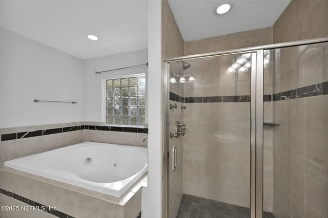 a bathroom with a bath tub and shower
