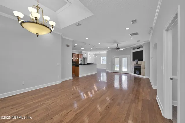 a view of an empty room and kitchen view