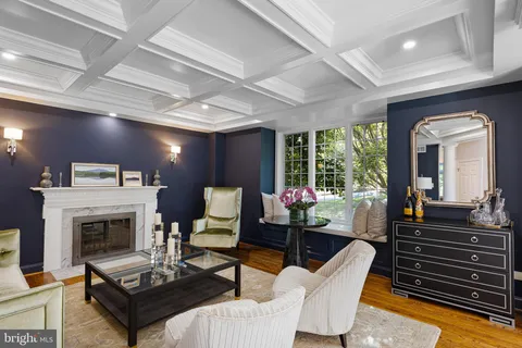 a living room with furniture fireplace and a large window