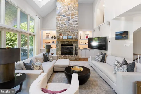 a living room with fireplace furniture and a flat screen tv
