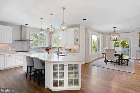 a large kitchen with a table and chairs