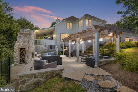 a view of a patio with couches table and chairs and potted plants