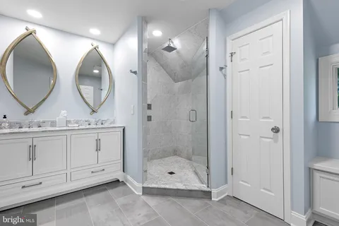 a bathroom with a sink mirror and a shower