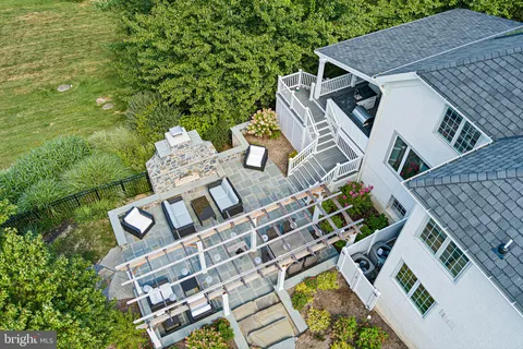 an aerial view of a house with a big yard and large trees