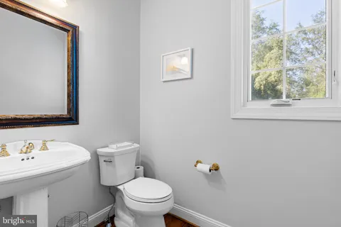 a kitchen with a stove and a white wooden floor