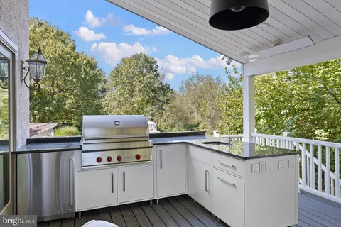 a living room with fireplace furniture and a large window
