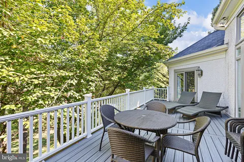a view of a patio with table and chairs and potted plants
