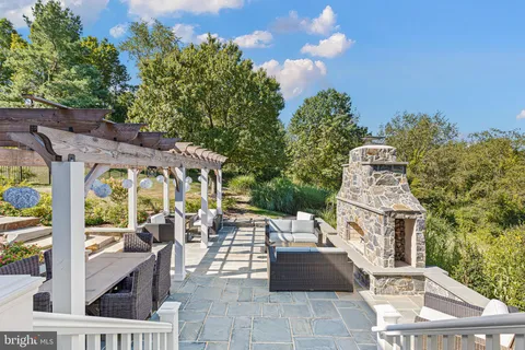 a view of a patio with a table and chairs and potted plants