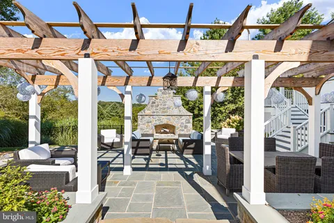 a view of a house with backyard water fountain and sitting area