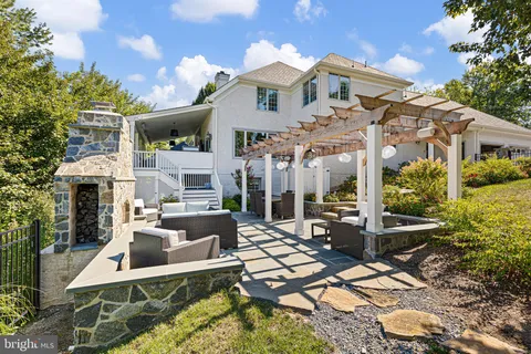 a front view of a house with a tree