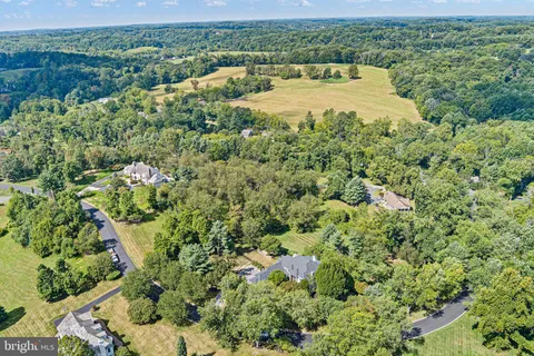 an aerial view of a house with a yard and lake view