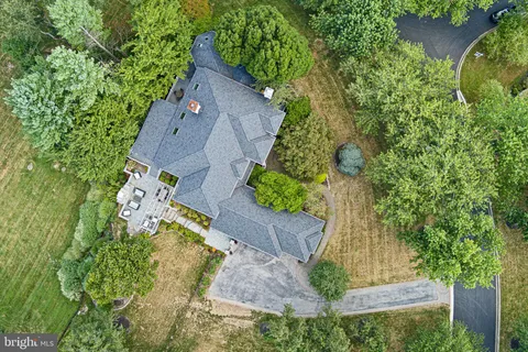 an aerial view of a house with a yard basket ball court and outdoor seating
