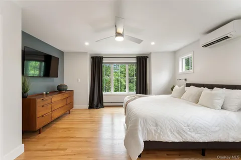 a spacious bedroom with a large bed and a flat screen tv