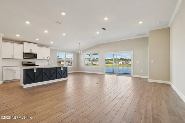 a view of kitchen with cabinets and wooden floor