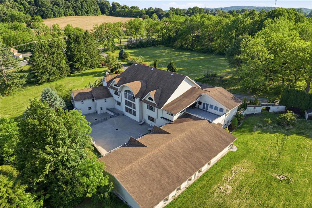6271 Batman Road Zionsville, PA 18092 - Photo 84 of 100 An aerial perspective showcases the home's sprawling layout amidst verdant landscaping and distant fields.