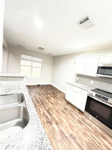 a kitchen with a stove and a sink