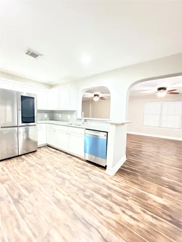 a view of a kitchen with wooden floor