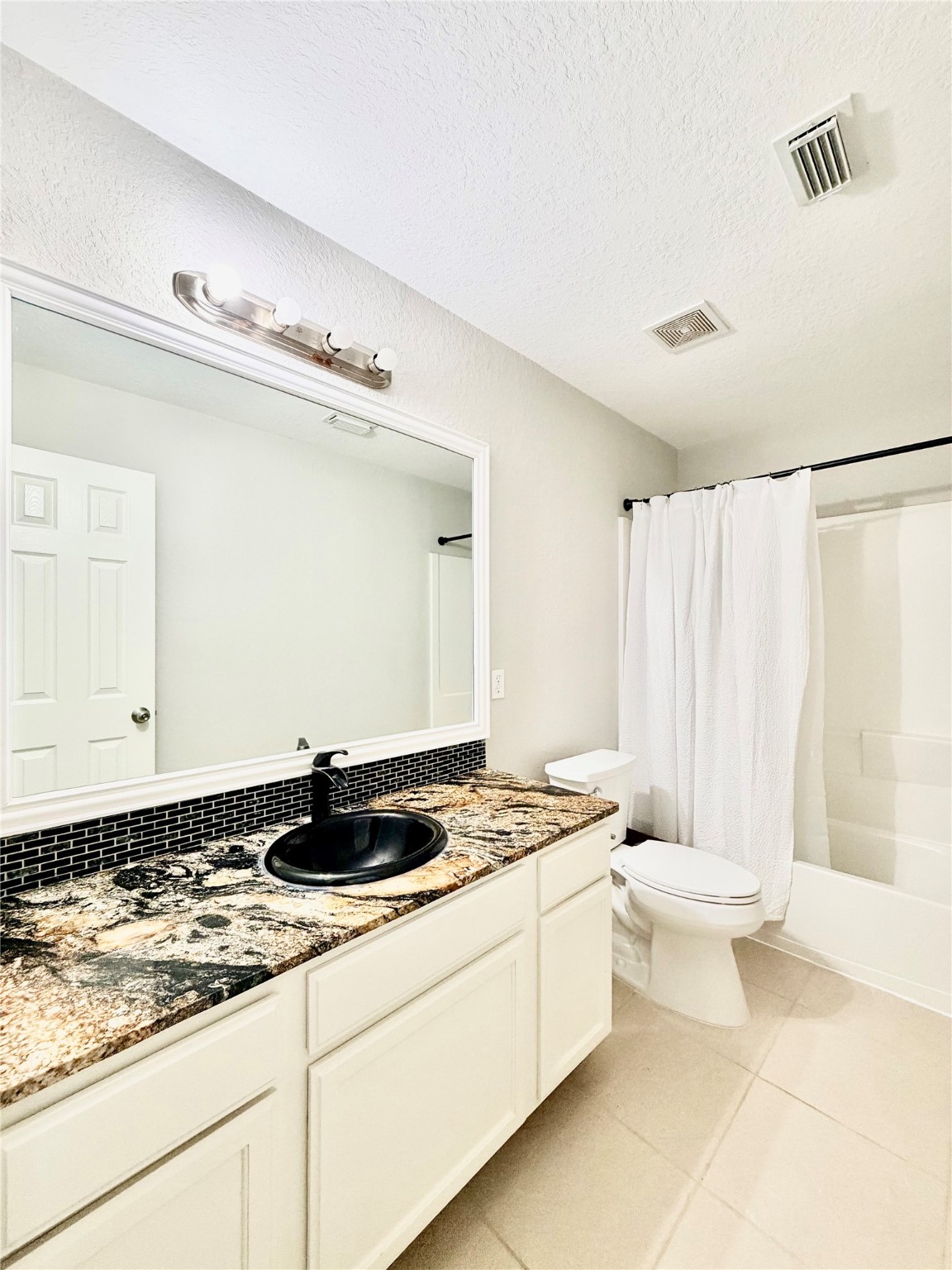 9110 Grandview Park Drive Spring, TX 77379 - Photo 10 of 28 a bathroom with a granite countertop sink a toilet a mirror and shower