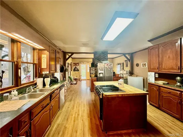 a kitchen with stainless steel appliances granite countertop a sink stove and wooden cabinets