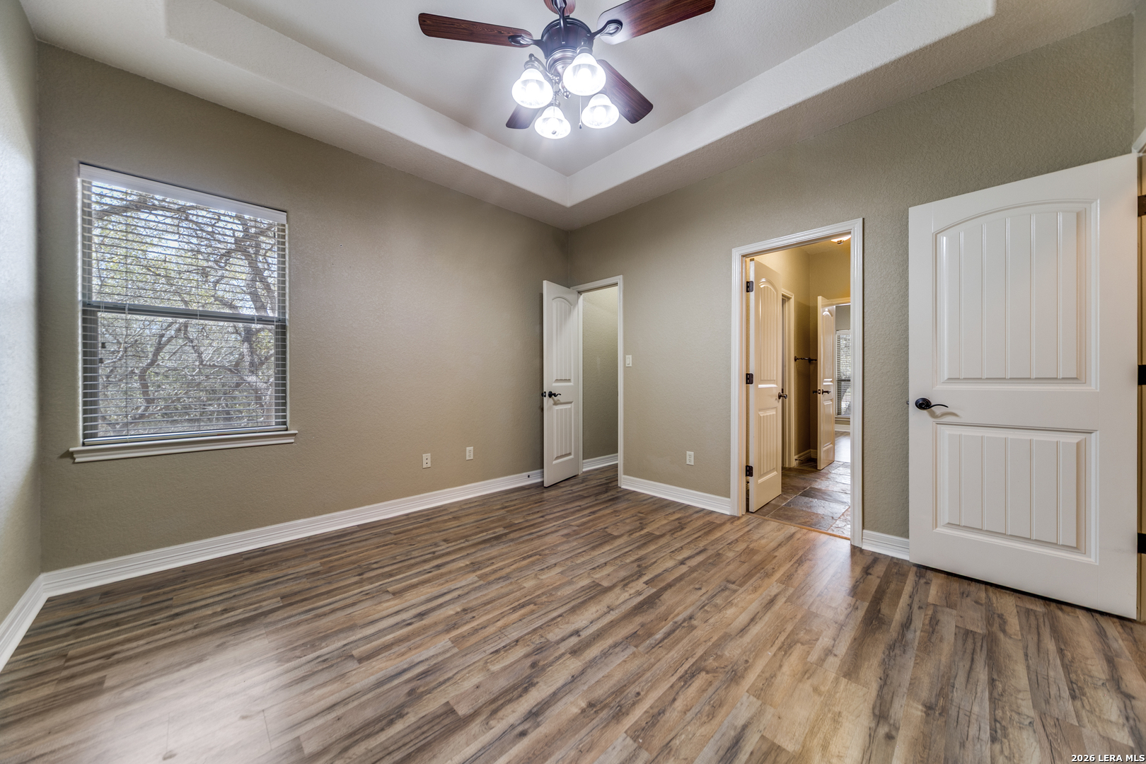 386 Wentworth Spring Branch, TX 78070 - Photo 18 of 30 an empty room with wooden floor chandelier fan and windows