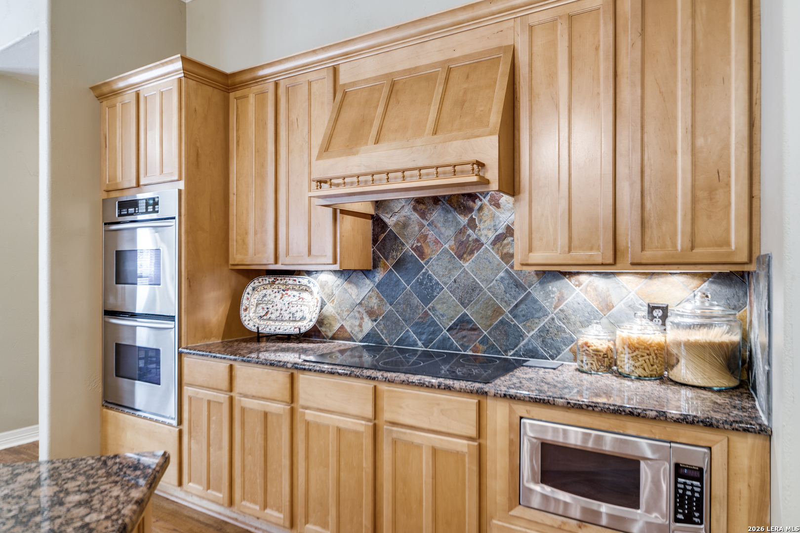 386 Wentworth Spring Branch, TX 78070 - Photo 10 of 30 a kitchen with granite countertop a sink a stove and cabinets