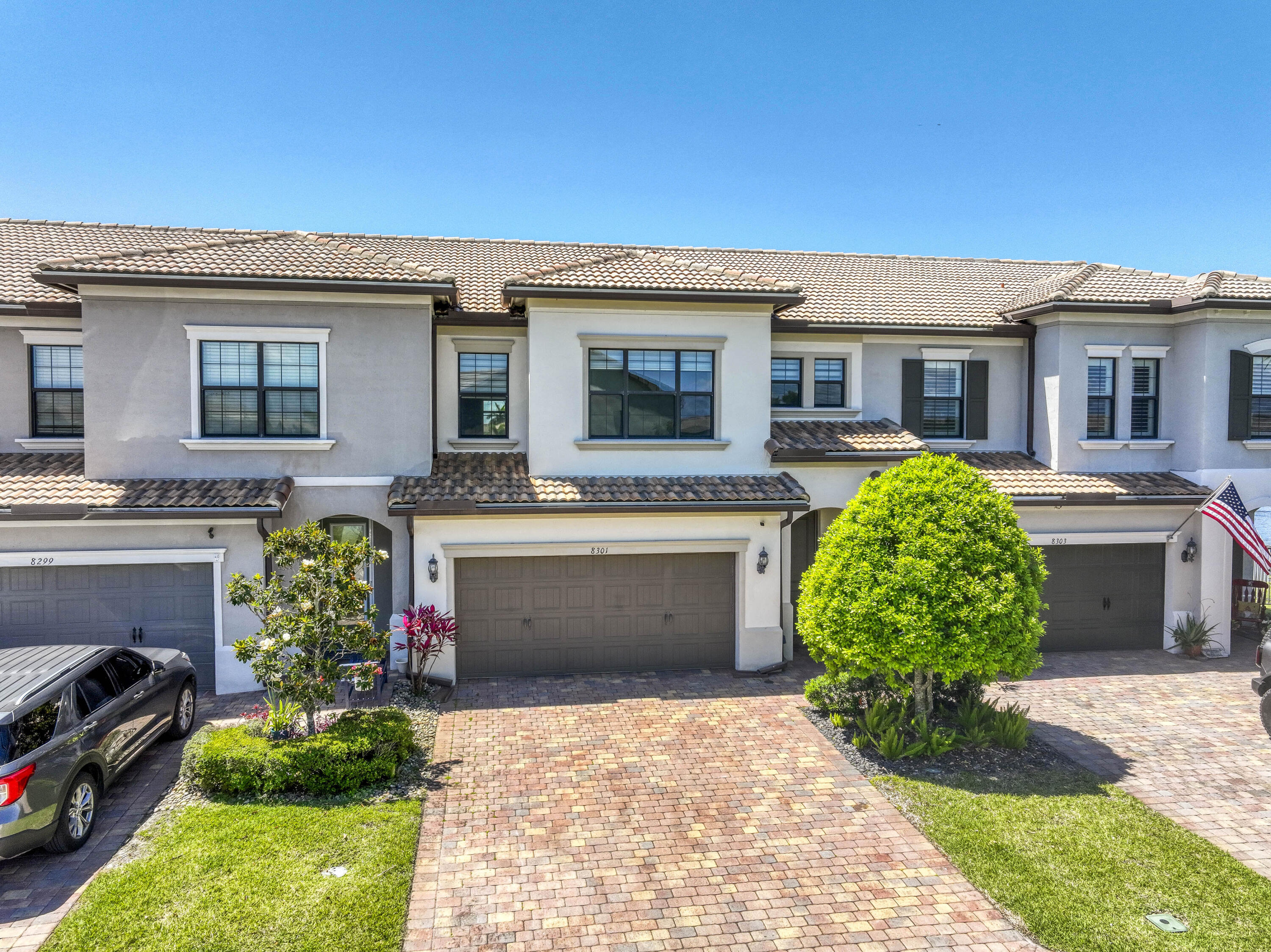 8301 Rearing Lane Lake Worth, FL 33467 - Photo 2 of 33 a front view of a house with a garden and yard