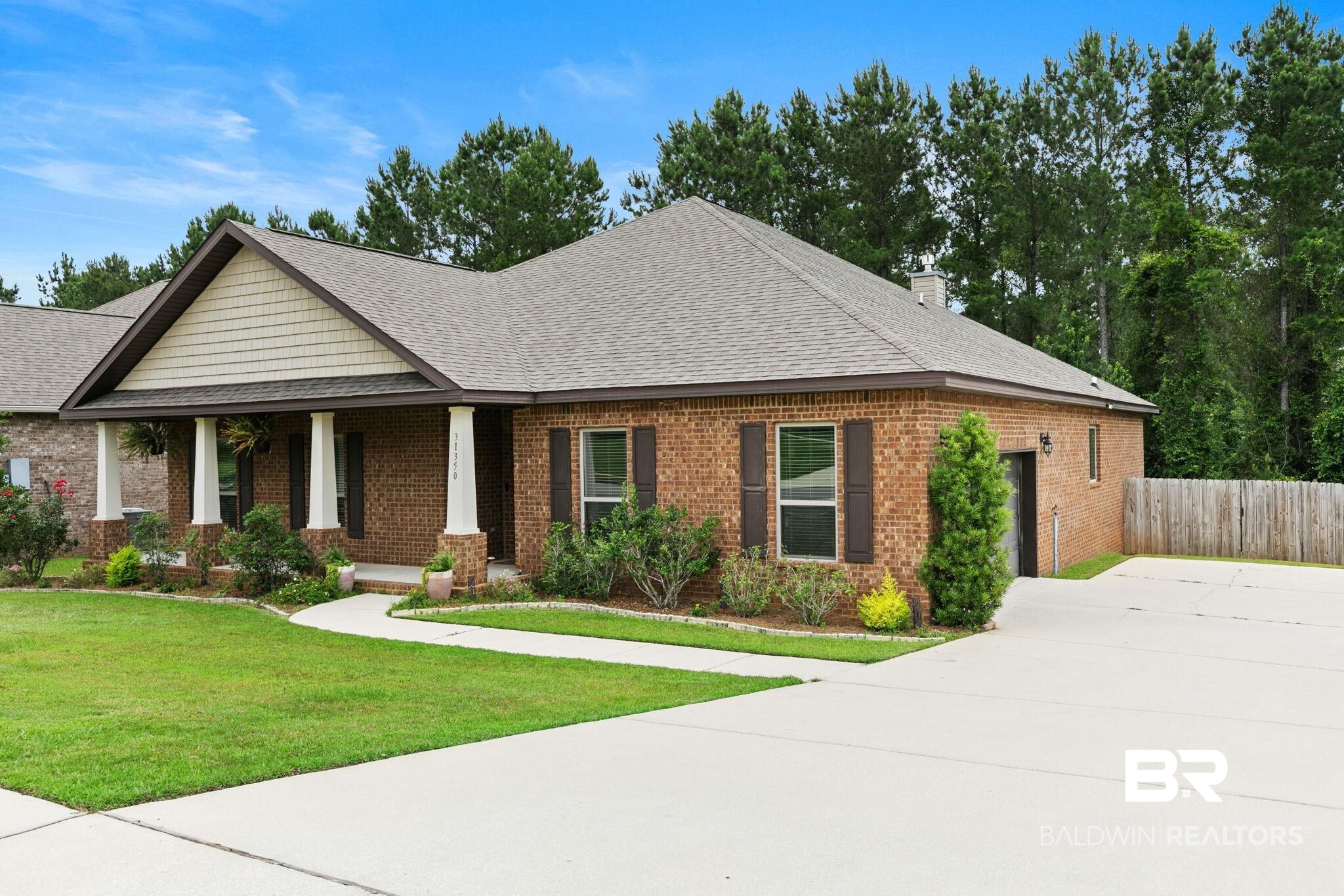 31350 Hoot Owl Road Daphne, AL 36527 - Photo 5 of 94 Brick exterior with a gabled roofline, featuring a covered front porch supported by four columns