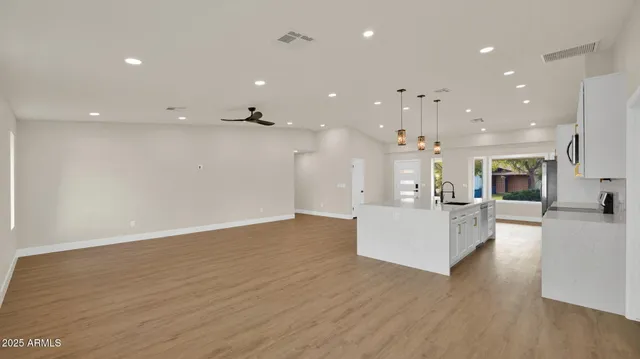 a living room with kitchen island furniture and a wooden floor