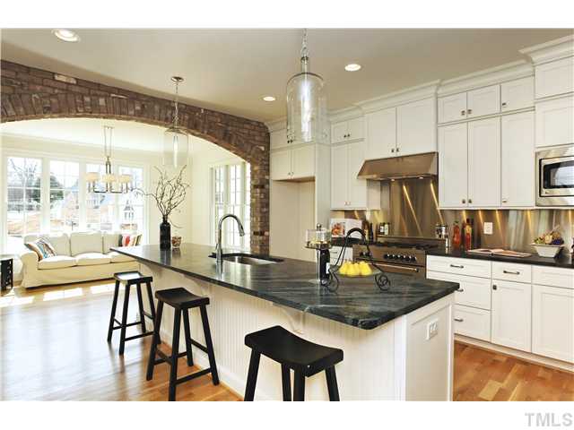 708 Wayne Drive Raleigh, NC 27608 - Photo 3 of 25 a kitchen with kitchen island granite countertop a table chairs sink and cabinets