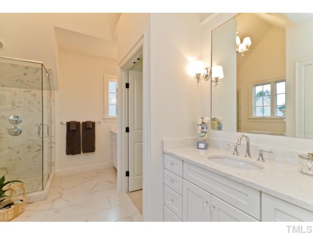 708 Wayne Drive Raleigh, NC 27608 - Photo 4 of 25 a bathroom with a shower sink and mirror