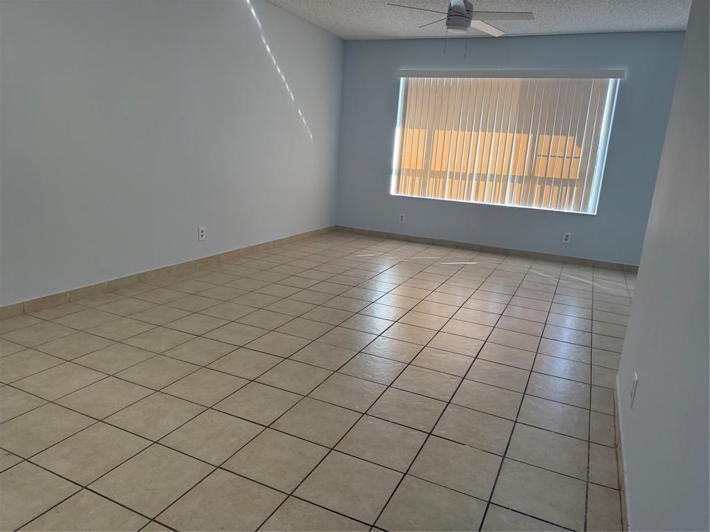 9930 Twin Lakes Drive, Unit 7L Coral Springs, FL 33071 - Photo 13 of 39 an empty room with windows
