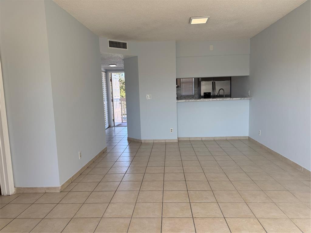 9930 Twin Lakes Drive, Unit 7L Coral Springs, FL 33071 - Photo 17 of 39 wooden floor in an empty room and a window