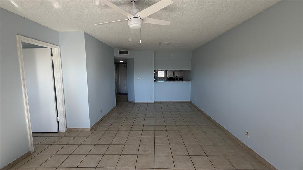 9930 Twin Lakes Drive, Unit 7L Coral Springs, FL 33071 - Photo 18 of 39 en empty room with cabinets and a ceiling fan
