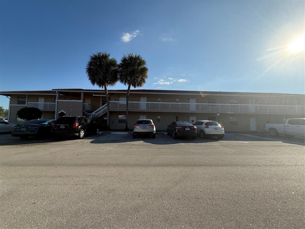 9930 Twin Lakes Drive, Unit 7L Coral Springs, FL 33071 - Photo 2 of 39 a car parked on the side of the road