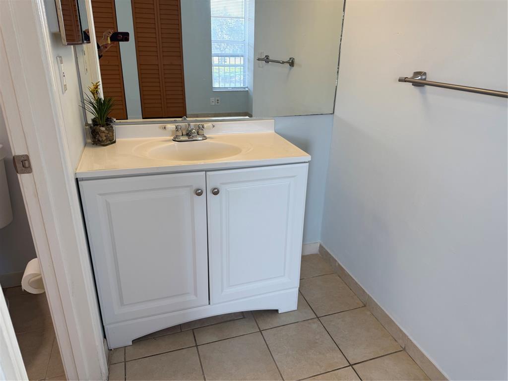 9930 Twin Lakes Drive, Unit 7L Coral Springs, FL 33071 - Photo 22 of 39 a bathroom with a sink and a mirror