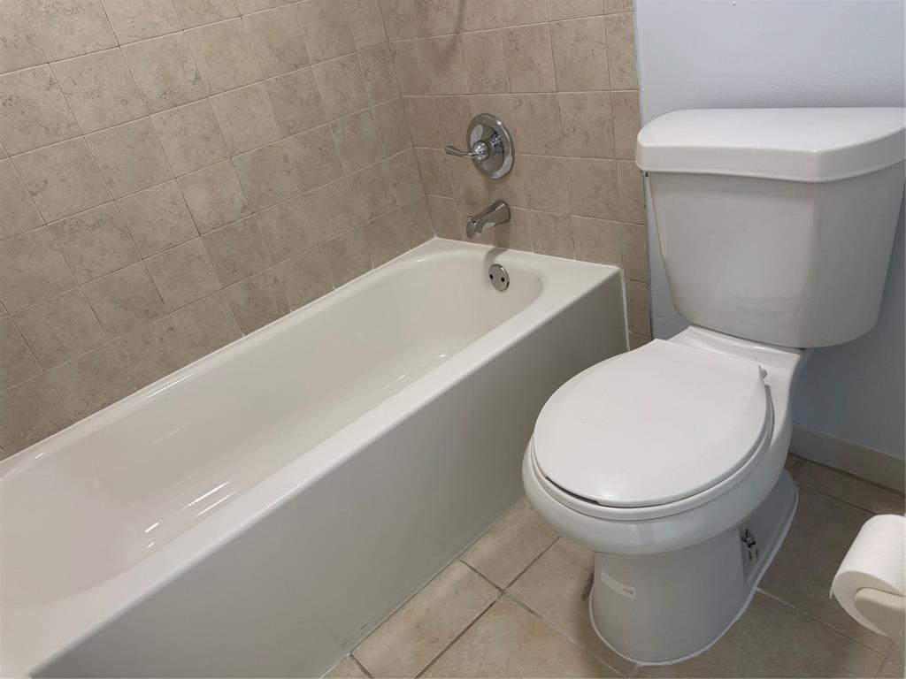 9930 Twin Lakes Drive, Unit 7L Coral Springs, FL 33071 - Photo 25 of 39 a white toilet sitting next to a bath tub and a sink