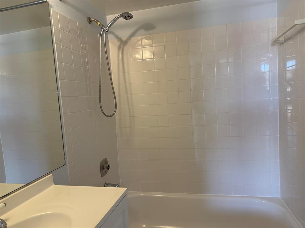 9930 Twin Lakes Drive, Unit 7L Coral Springs, FL 33071 - Photo 29 of 39 a bathroom with a bath tub with a shower