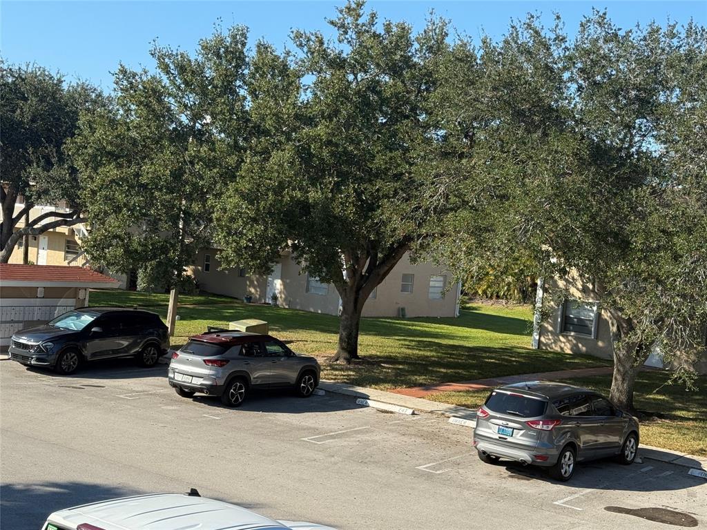 9930 Twin Lakes Drive, Unit 7L Coral Springs, FL 33071 - Photo 37 of 39 a car parked in front of a house