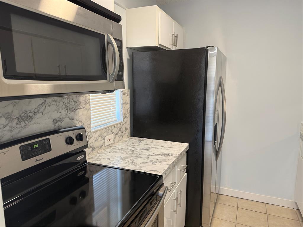 9930 Twin Lakes Drive, Unit 7L Coral Springs, FL 33071 - Photo 4 of 39 a kitchen with granite countertop cabinets and steel stainless steel appliances