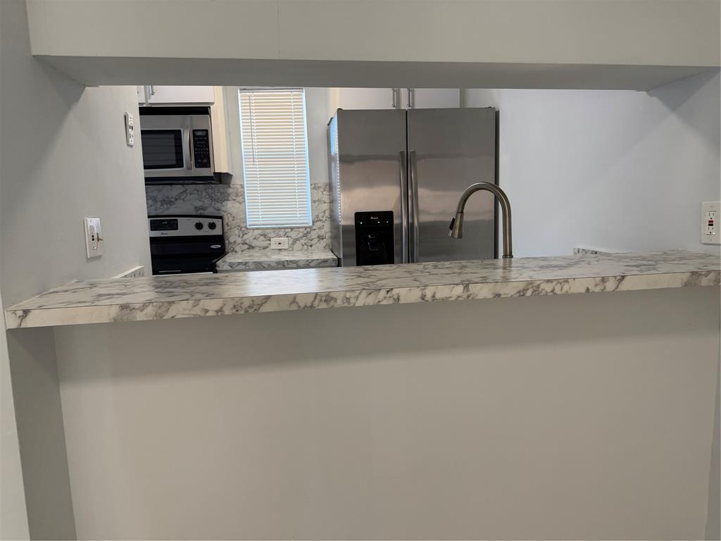 9930 Twin Lakes Drive, Unit 7L Coral Springs, FL 33071 - Photo 7 of 39 a view of a livingroom with a fireplace