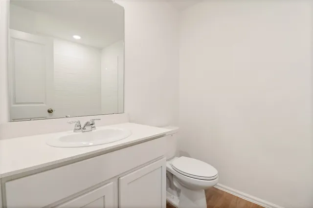 a bathroom with a sink toilet and a mirror