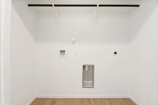 a view of a backyard with potted plants and wooden fence