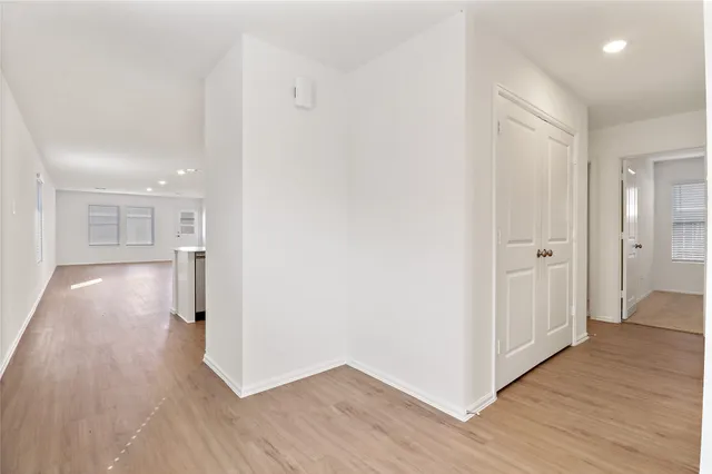 a view of a hallway with wooden floor