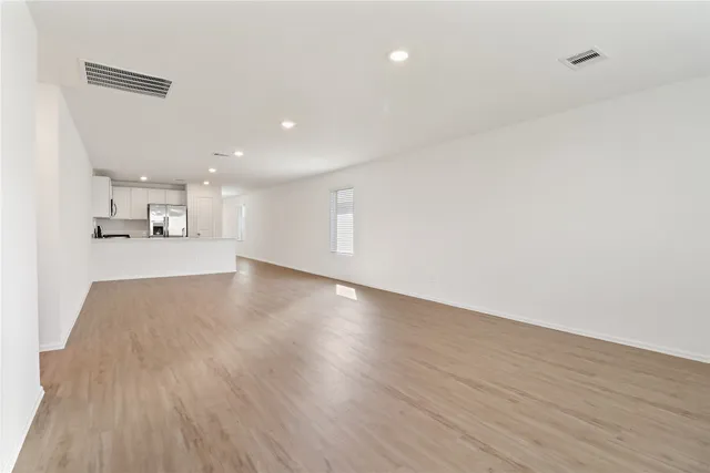 a view of a kitchen with a dishwasher and wooden floor