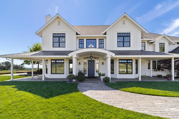 a front view of a house with a yard and porch
