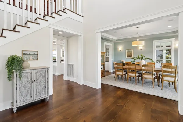 a view of a livingroom with wooden floor and stairs