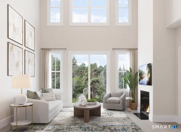 a living room with furniture and a potted plant