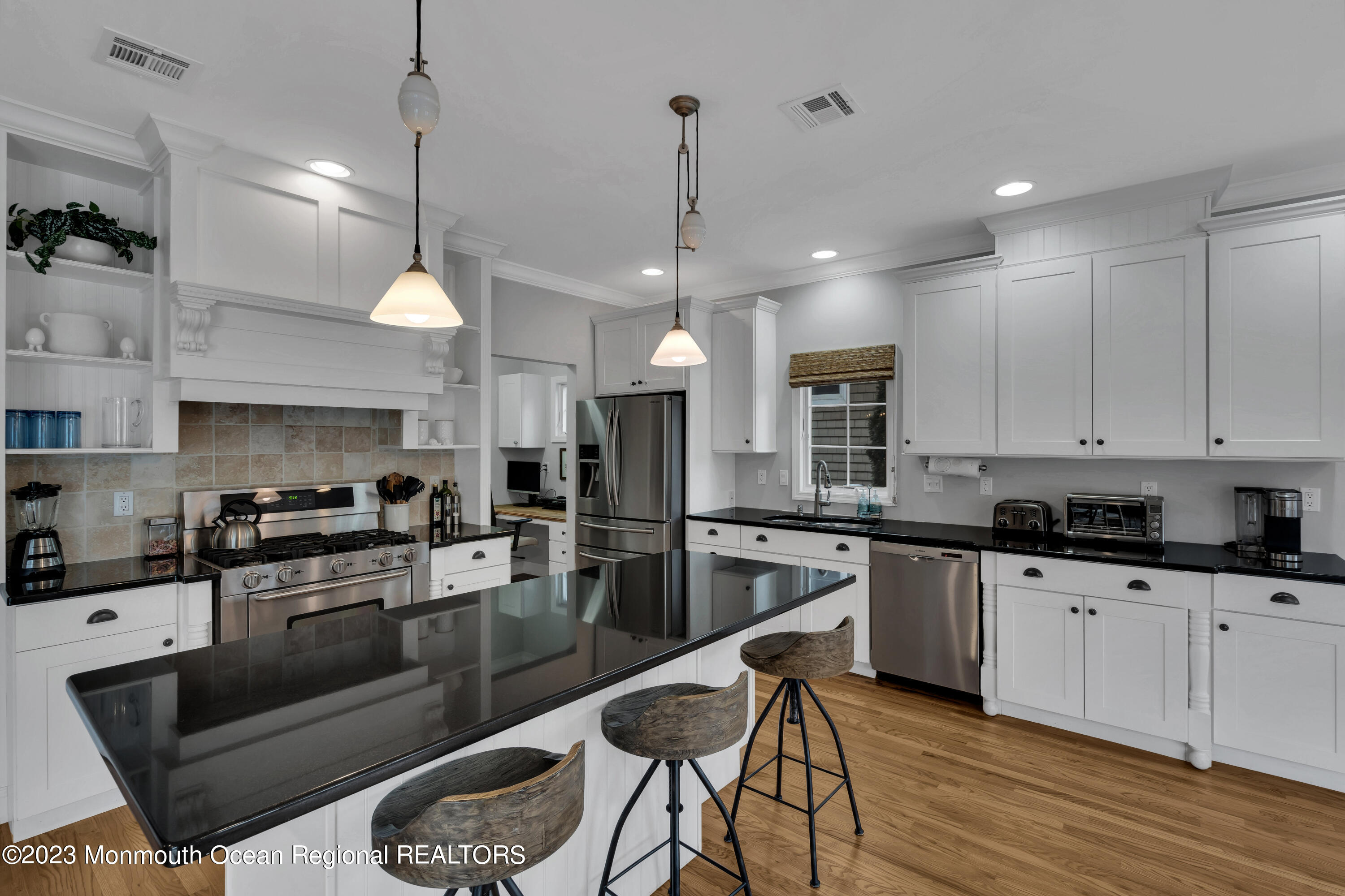 89 Mclean Avenue Manasquan, NJ 08736 - Photo 12 of 38 a kitchen with granite countertop a stove a sink a refrigerator and chairs
