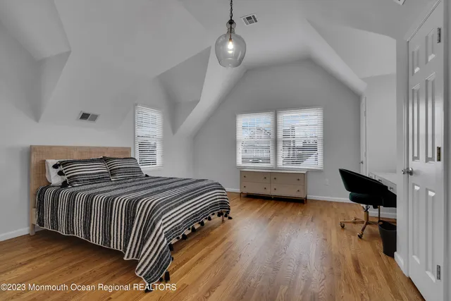 a bedroom with bed and a window