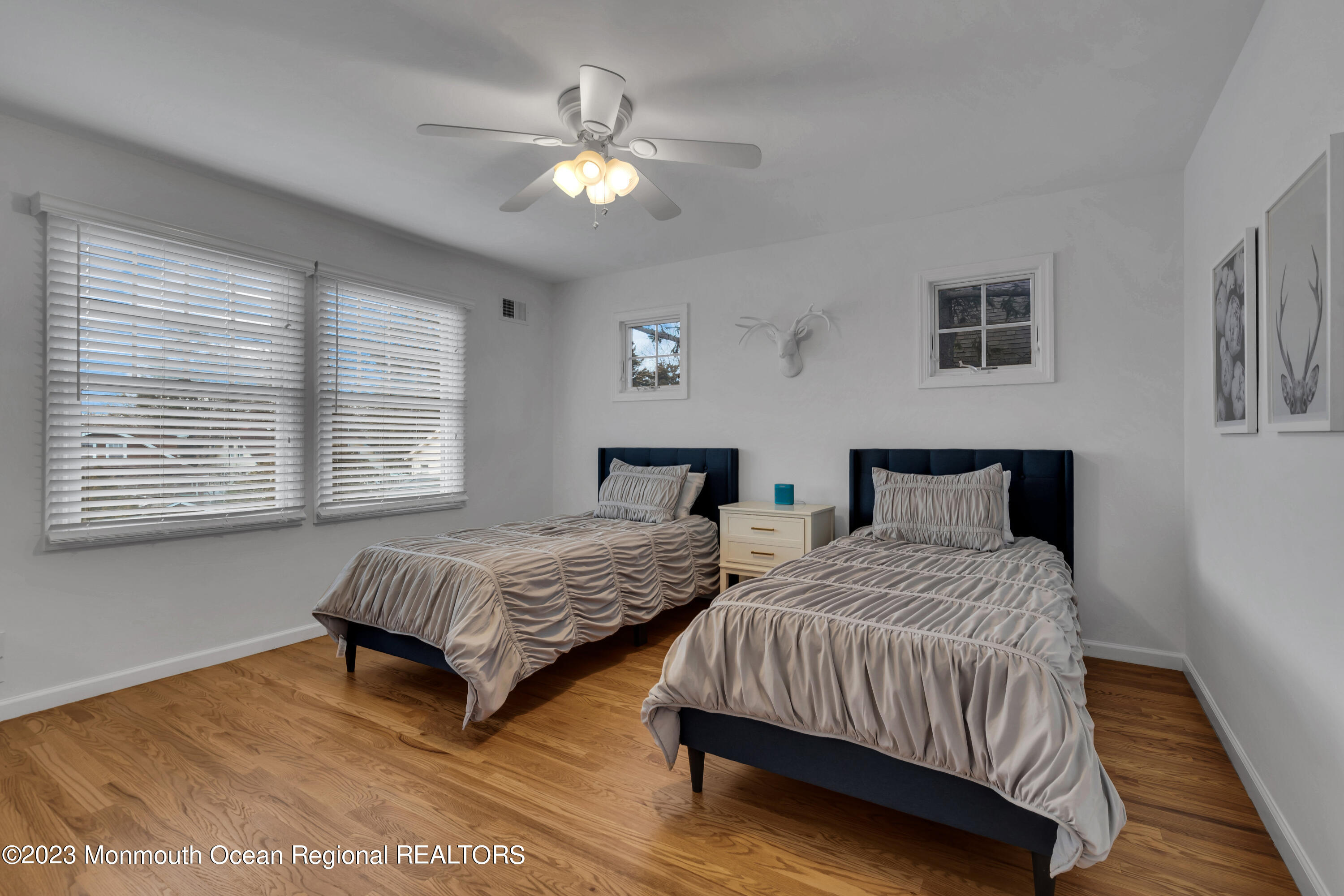 89 Mclean Avenue Manasquan, NJ 08736 - Photo 26 of 38 a bedroom with two beds and a chandelier